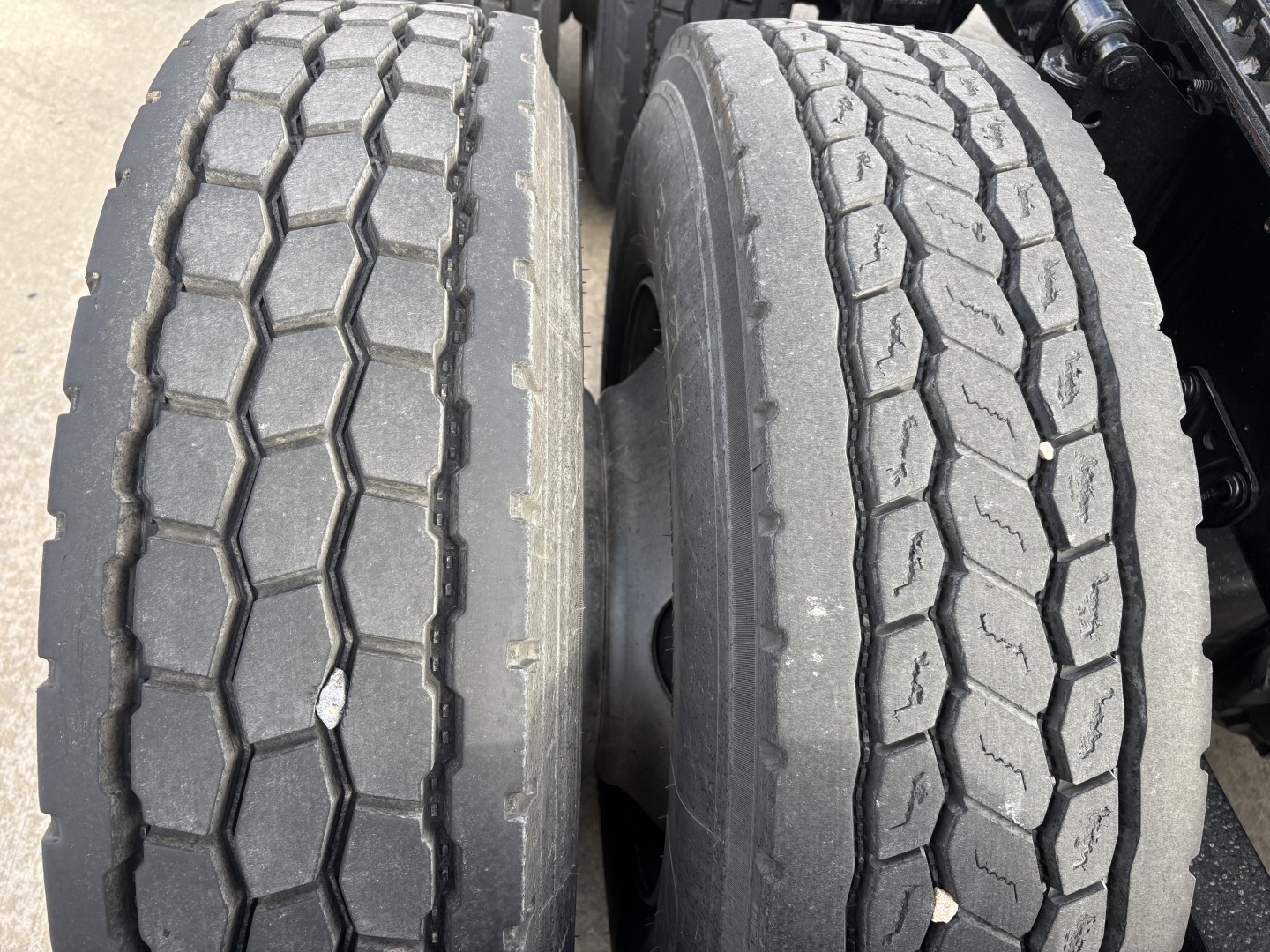 Dual rear truck tires with tread pattern visible on Mack AN64T chassis.