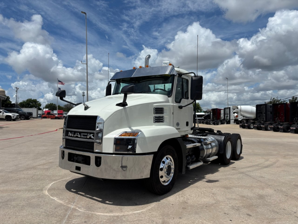 2020 Mack AN64T conventional daycab truck shown in a dealership lot, front-left view with white cab, dual rear axles, chrome bumper, and Mack grille.