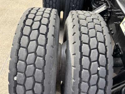 Dual rear tires of a 2020 Mack AN64T conventional daycab showing tread pattern and sidewall details.