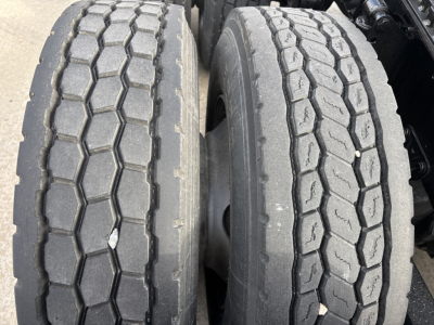 Dual rear truck tires with tread pattern visible on Mack AN64T chassis.