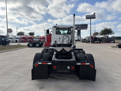 Tractor truck rear view showing fifth-wheel hitch and dual rear axles on a Mack AN64T daycab