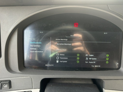 Dashboard screen of a Kenworth T680 showing system warnings and check marks for various subsystems, with a red warning indicator at top and a time/weather reading 76°F.