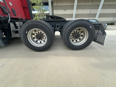 Twin rear wheels of a Kenworth T680 tractor showing steel rims and Goodyear tires.