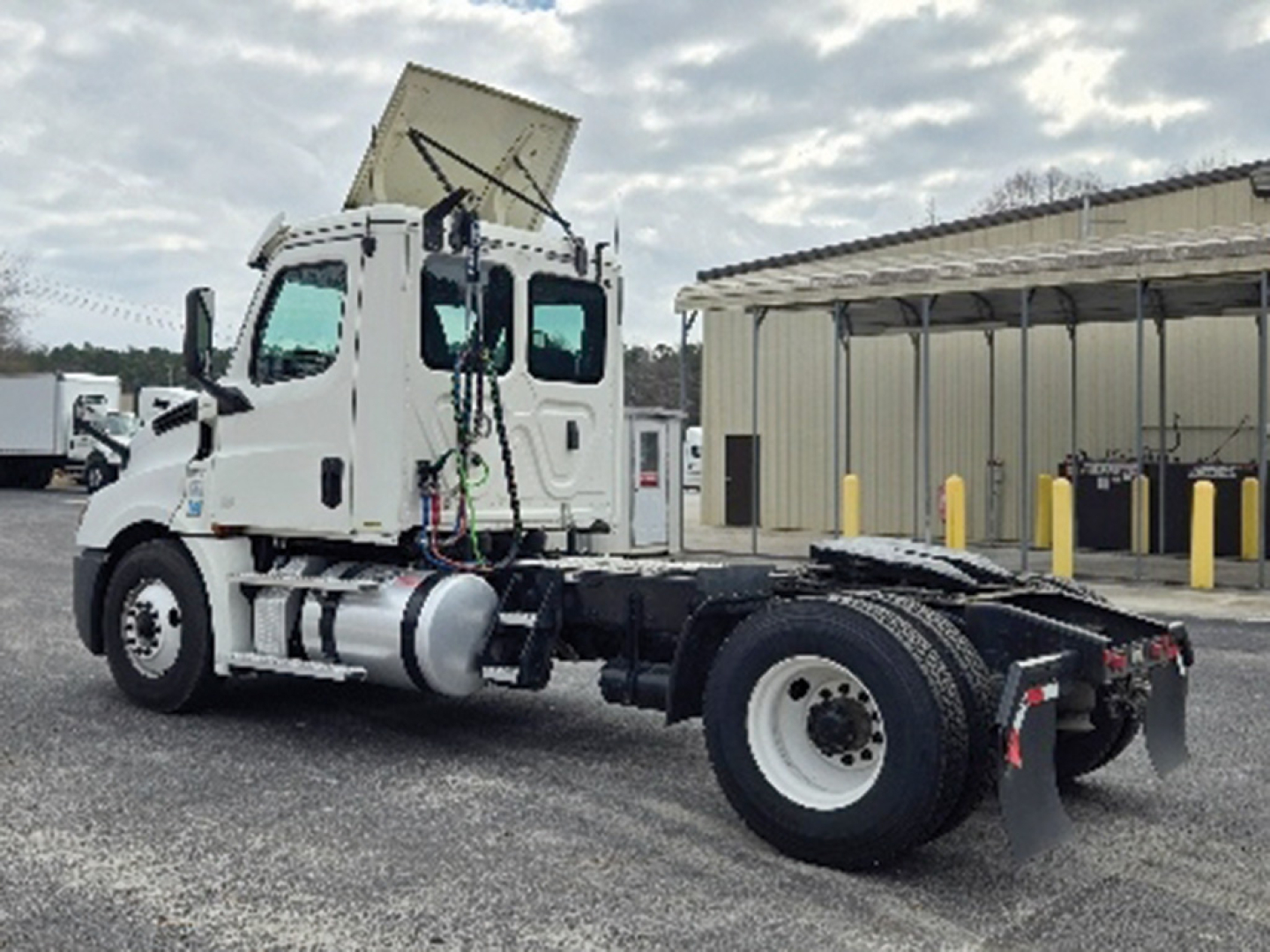 Truck chassis of a 2020 Freightliner Cascadia126 daycab with cab, dual rear wheels, and dump trailer hitch. Visible labels include VIN and stock number on the listing text.