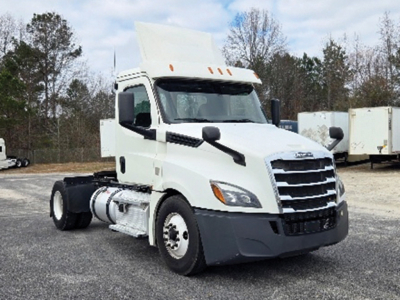 Truck cab of a white 2020 Freightliner Cascadia126 conventional daycab, showing front grille, headlights, and side mirrors.
