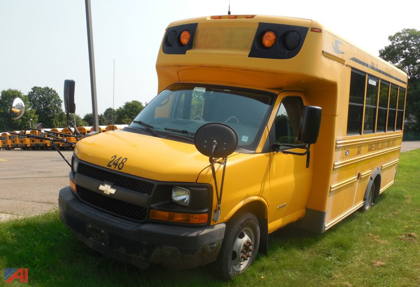 Chevrolet Express school bus with wheelchair lift, yellow color, front view showing chassis and passenger door, 248 number on hood