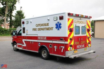 Ambulance rear and side view showing Cutchogue Fire Department and RESCUE lettering with blue Star of Life symbol.