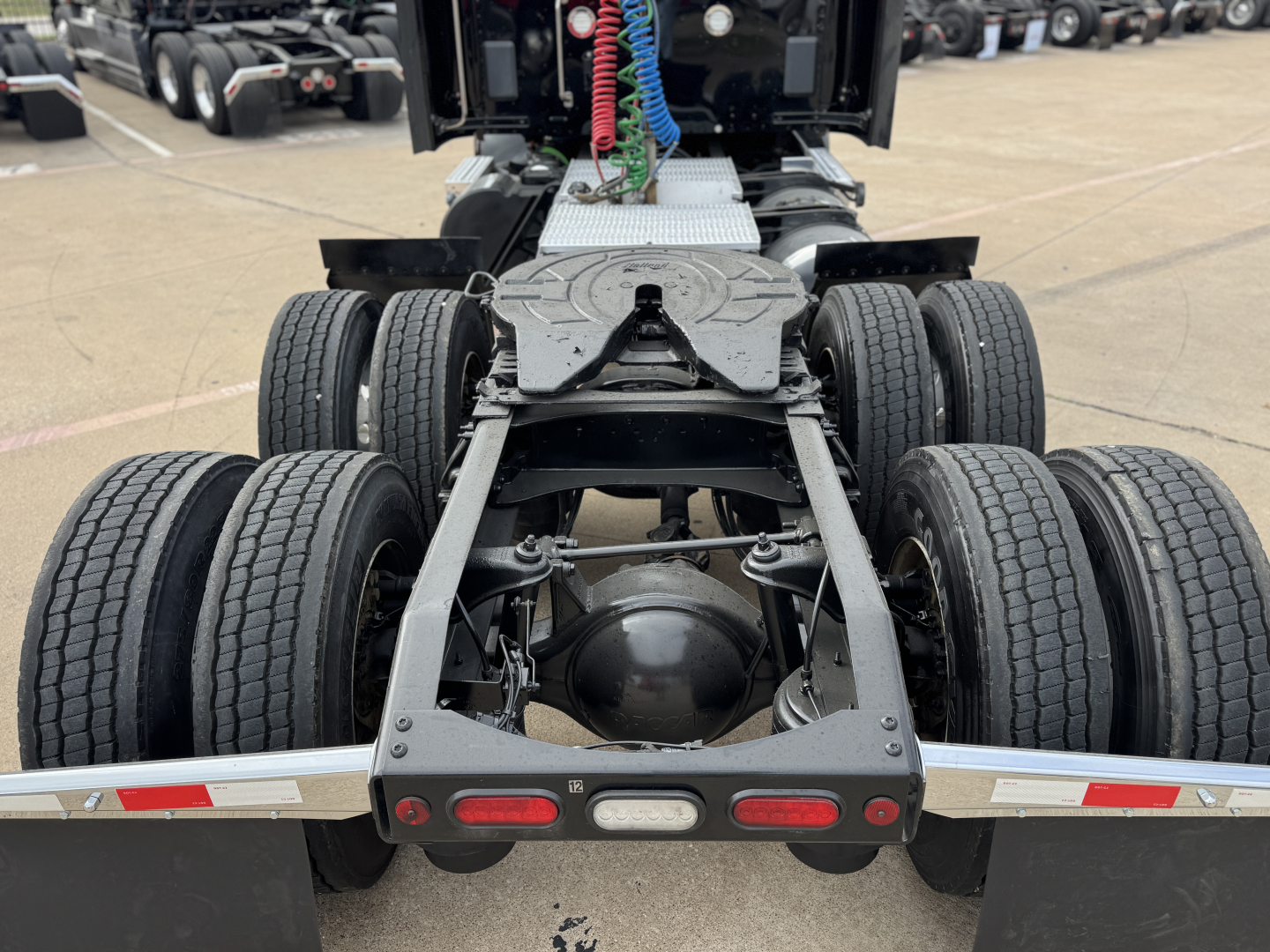 Peterbilt 579 truck chassis rear view showing dual rear axles and fifth wheel mounting platform.