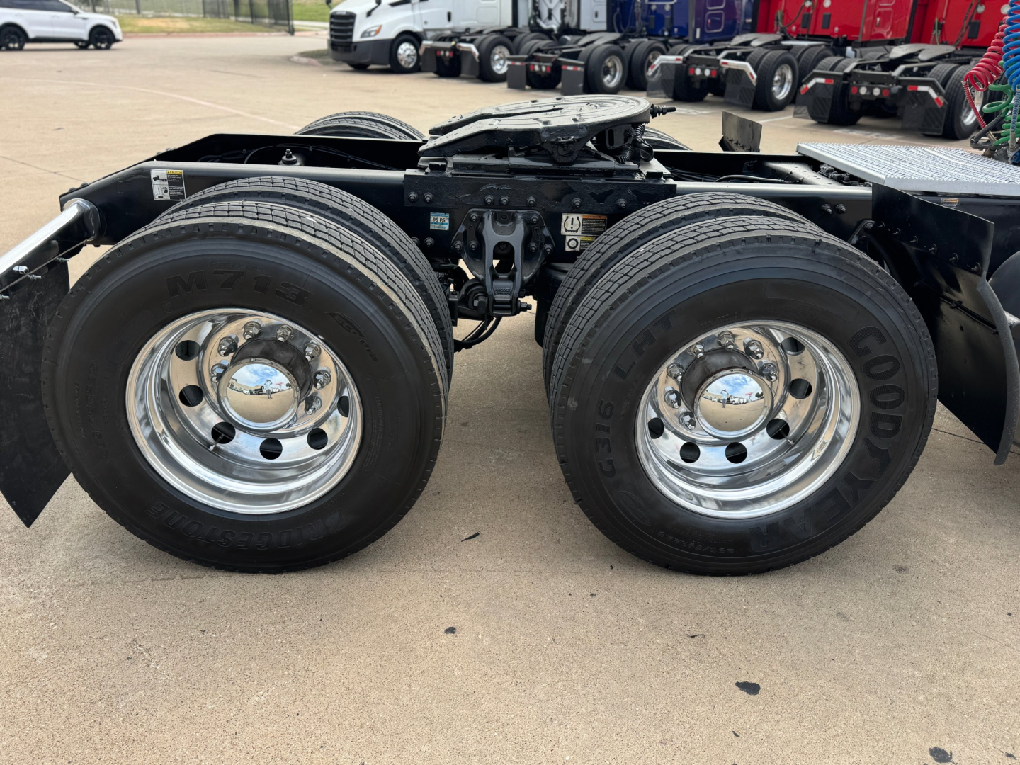 Peterbilt 579 semi-truck chassis showing two rear dual wheels and fifth wheel coupling plate.