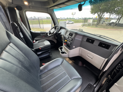 Interior of a 2022 Peterbilt 579 cab showing steering wheel, dashboard, and seats.
