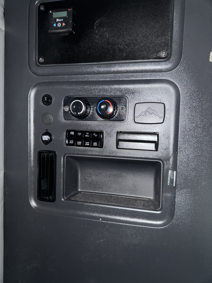 Truck cab interior panel showing HVAC controls and storage pocket; no legible model text visible