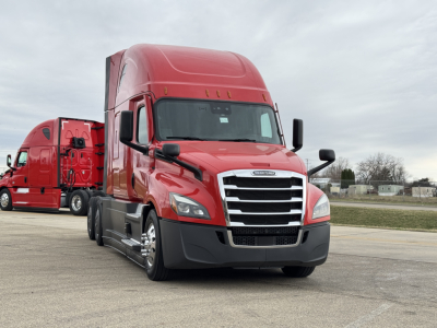 Freightliner Cascadia 126 sleeper tractor in red, front view with chrome grille and dual rear axles; VIN plate or window not readable in image.