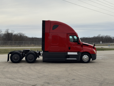 Freightliner Cascadia 126 sleeper tractor side view showing cab and rear wheels, red exterior, no visible damage.