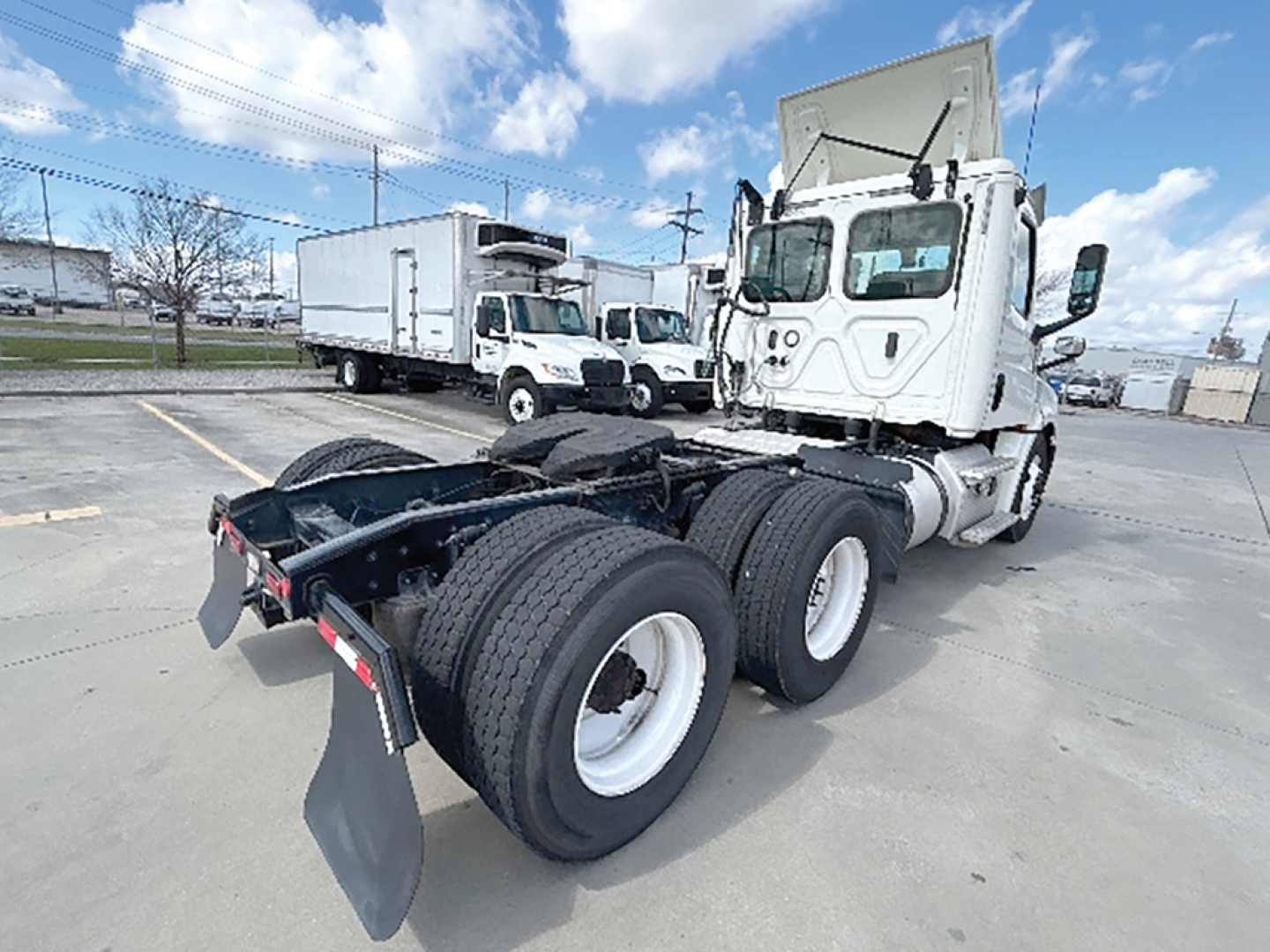 Truck chassis and rear view of a 2019 Freightliner Cascadia126 daycab showing dual rear axles and fifth wheel hitch area