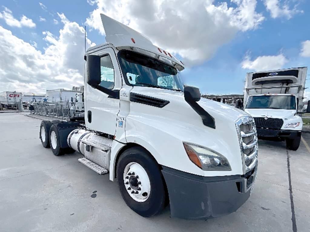 Truck showroom image of a white 2019 Freightliner Cascadia126 conventional daycab with sleeper area, front grille, side mirrors, and dual rear axles visible.