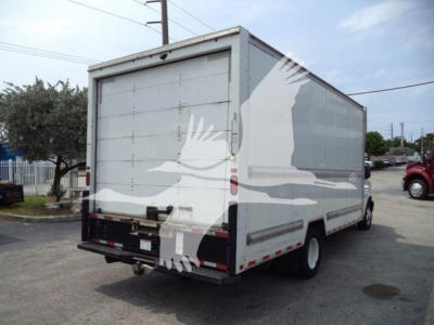 Rear and side view of a white GMC G3500 box truck with cargo area; visible text includes no legible markings on doors, tailgate, or decals.