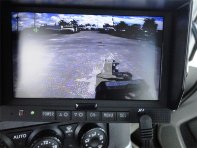 Dashboard display of a 2022 Kenworth W900 rollback trucks showing a view from the driver’s monitor with controls below.