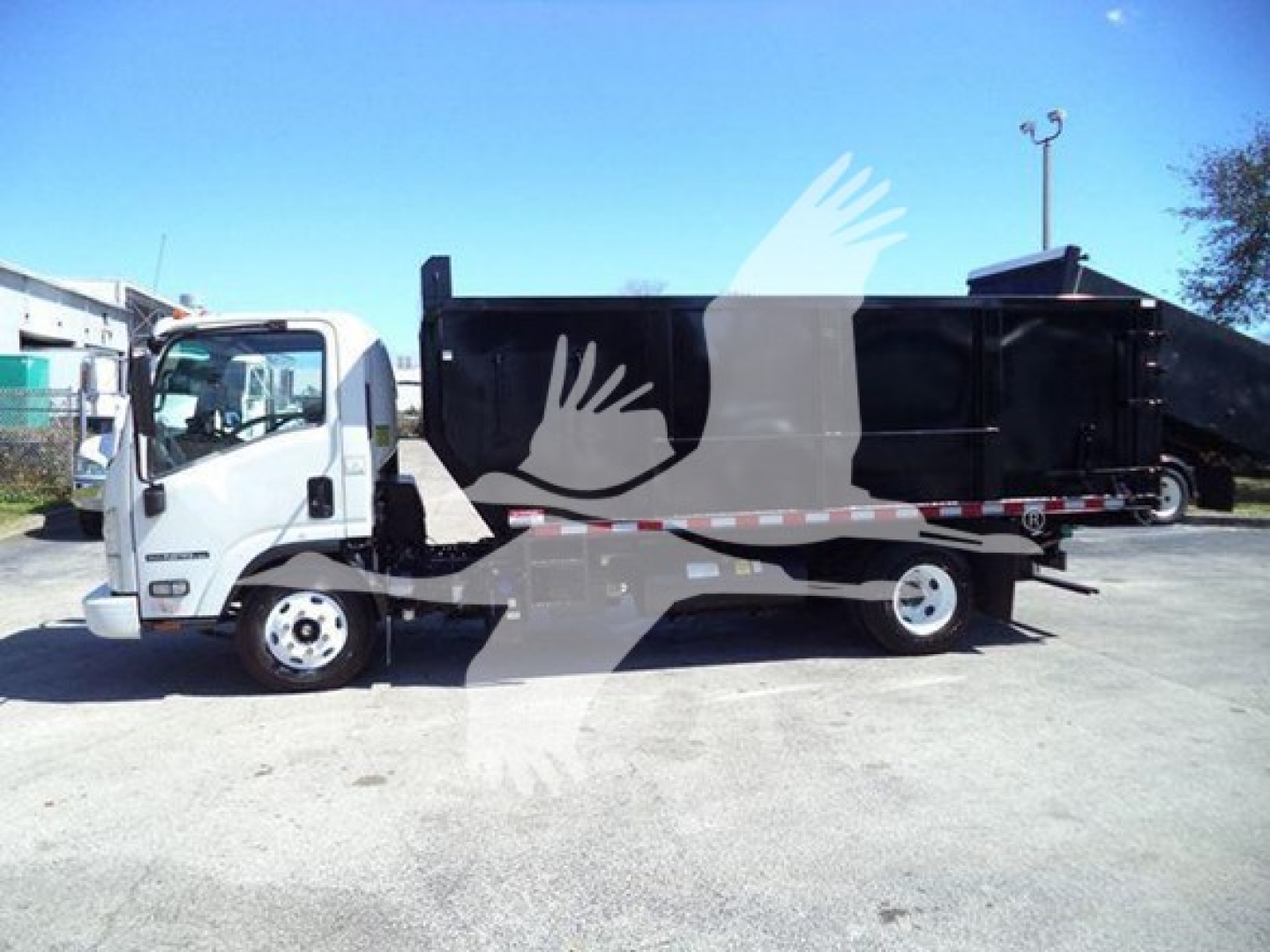 Isuzu NPR dump truck side view showing cargo bed and cab details
