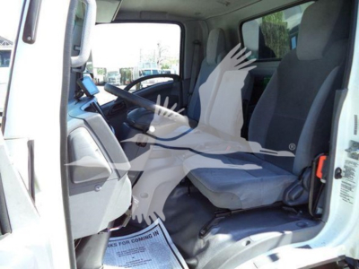 Isuzu NPR cab interior photo showing driver seat and front passenger seat with dashboard and steering wheel visible