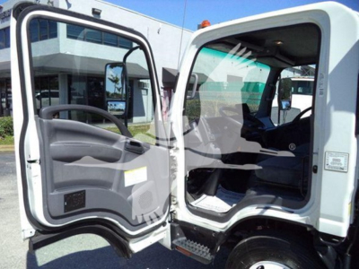 Isuzu NPR truck cab interior with both doors open, showing driver seat and dashboard, white exterior, step rails, and interior gauges.
