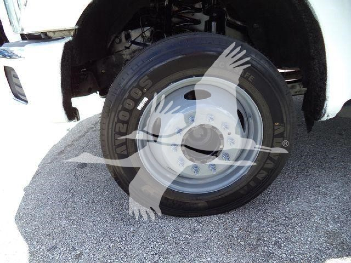 Wheel and front fender of a 2016 Ford F550 dump truck showing a steel wheel and tire