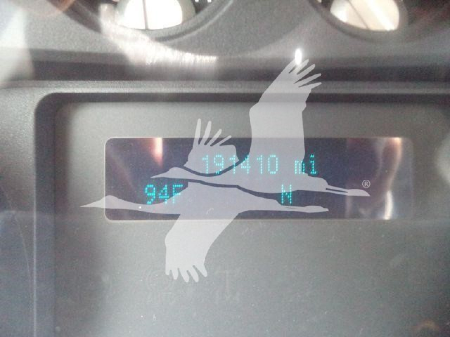 Dashboard display showing 19,010 miles with 94F temperature and fuel gauge in a Ford F-550 dump truck.