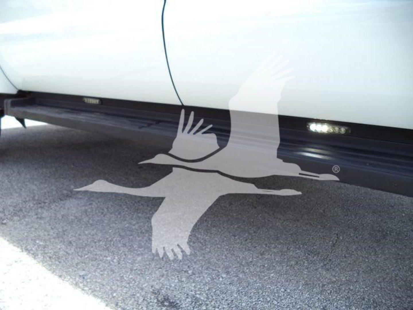 Side rail of a Ford F-550 dump truck showing undercarriage and running boards.