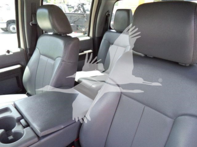 Interior front seats of a 2016 Ford F550 truck showing gray fabric seats and center console.