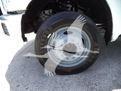 Wheel and front fender of a 2016 Ford F550 dump truck showing a steel wheel and tire
