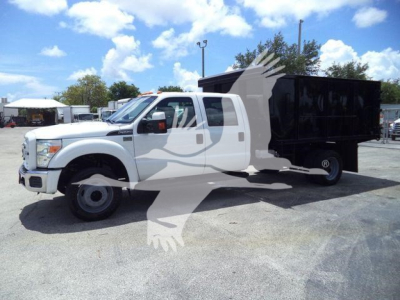 Ford F-550 dump truck with white cab and black dump bed, side view showing extended cab and hydraulic system