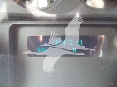 Dashboard display showing 19,010 miles with 94F temperature and fuel gauge in a Ford F-550 dump truck.