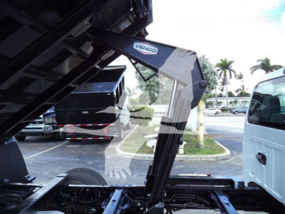 Truck bed with hydraulic arm labeled Venco and black metal frame visible inside truck chassis.