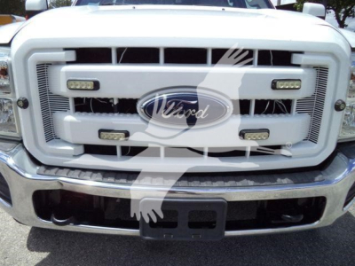 Front view of a Ford F-550 grille with Ford emblem, four rectangular lights, and bumper; no additional readable labels or numbers visible.
