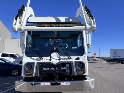 Front view of a new 2026 Mack TE64 garbage truck showing grille, headlights, Mack emblem, and front bumper.