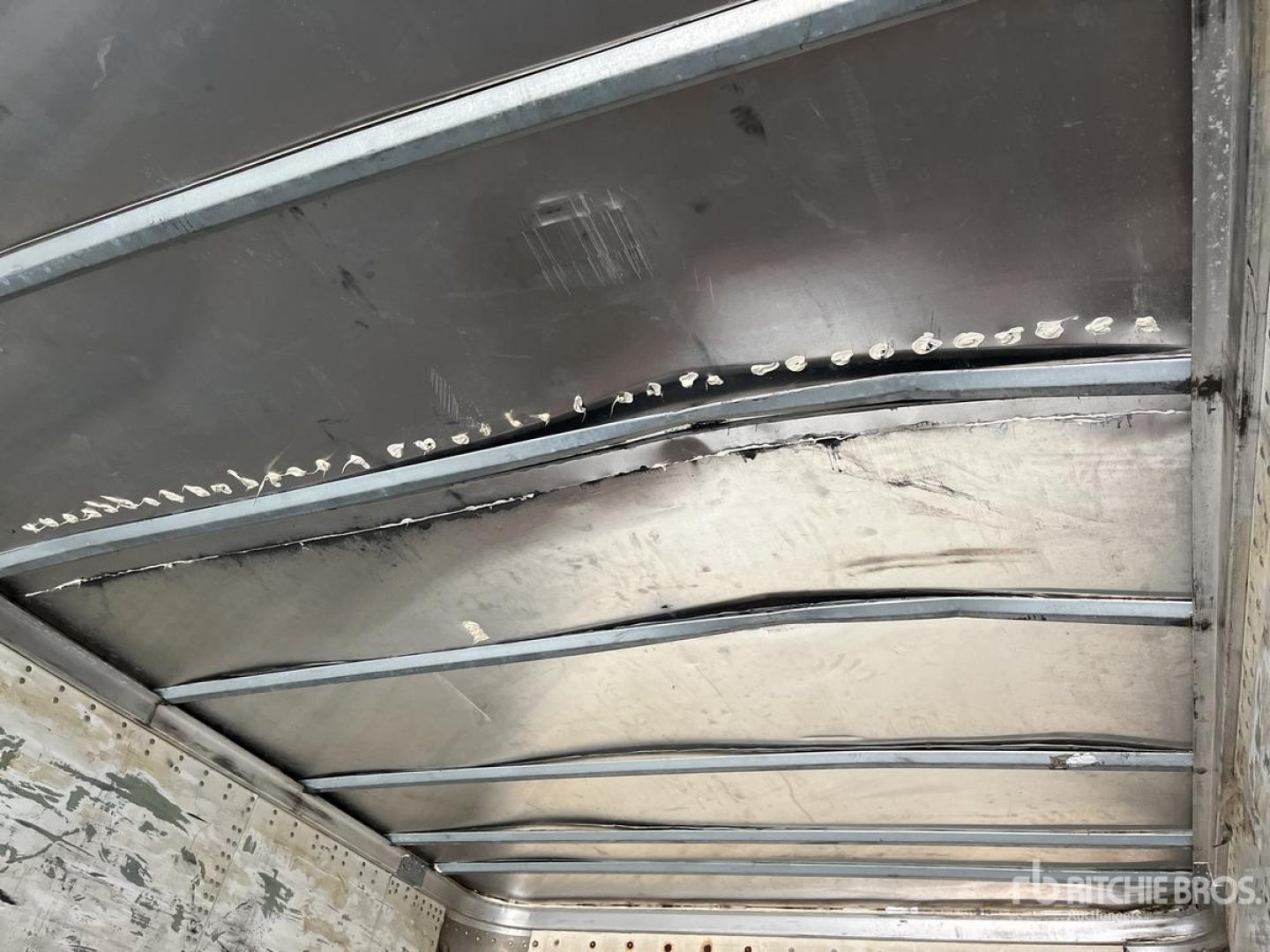 Trailer interior ceiling with metal framing and riveted panels