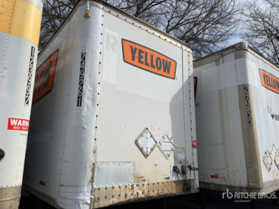 Trailer rear doors with YELLOW label on a Wabash DVDBHPC trailer in a lot, with another trailer beside it.
