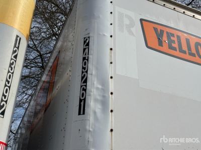 Trailer side with vertical black date/serial sticker and partial yellow post; large 'YEL' from Yellow trailer company branding on the side.