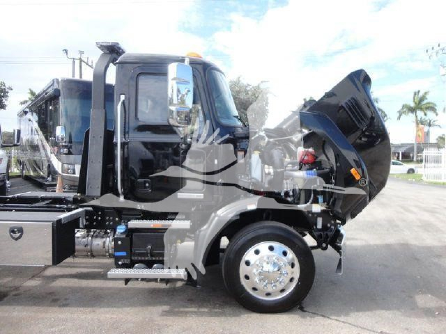2026 Mack MD6 dump truck side view showing front hood raised and engine area exposed