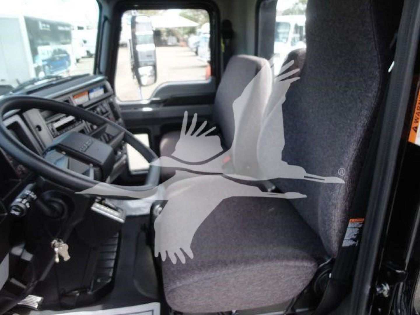 cab interior of a Mack MD6 truck showing steering wheel, dashboard, and driver seat with imprint watermark across image