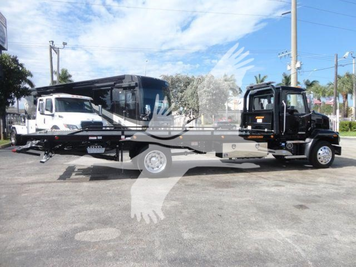 MD6 rollback truck on flatbed with tow truck-style cab and autogrip branding visible.