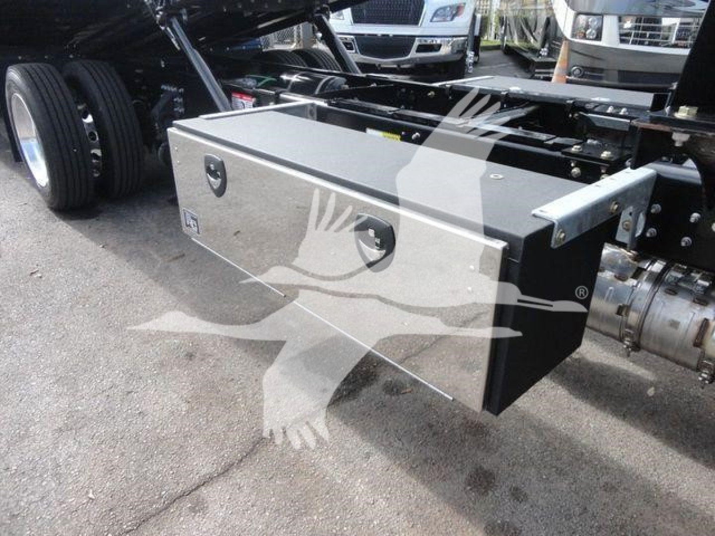 MD6 truck chassis showing a metallic toolbox mounted on the side with a badge and locking handles.