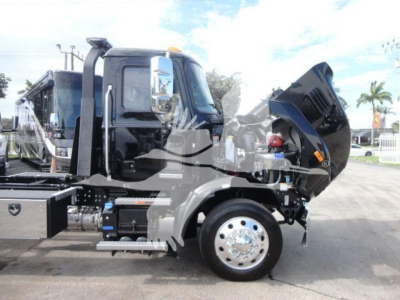 2026 Mack MD6 dump truck side view showing front hood raised and engine area exposed
