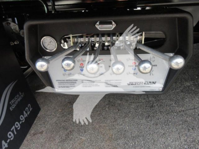 Control panel of Mack MD6 rollback system with multiple levers and gauges labeled with operating instructions.