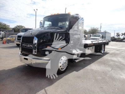 MD6 tow truck side view showing Mack grille and flatbed with chrome wheels and orange marker lights.