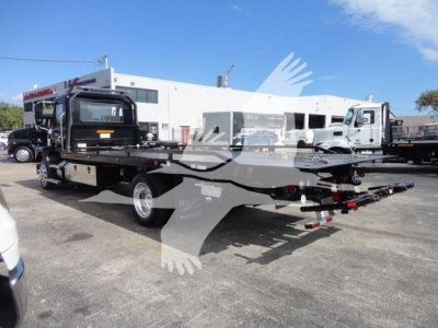 MD6 rollback truck showing flatbed with spare tire and equipment mounted, rear view with hitch and dual rear wheels, Mack MD6 autogrip stock image