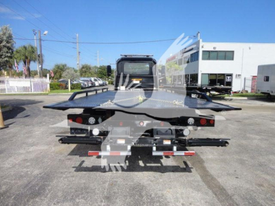 Tow truck deck showing MD6 rollback platform and rear lights.