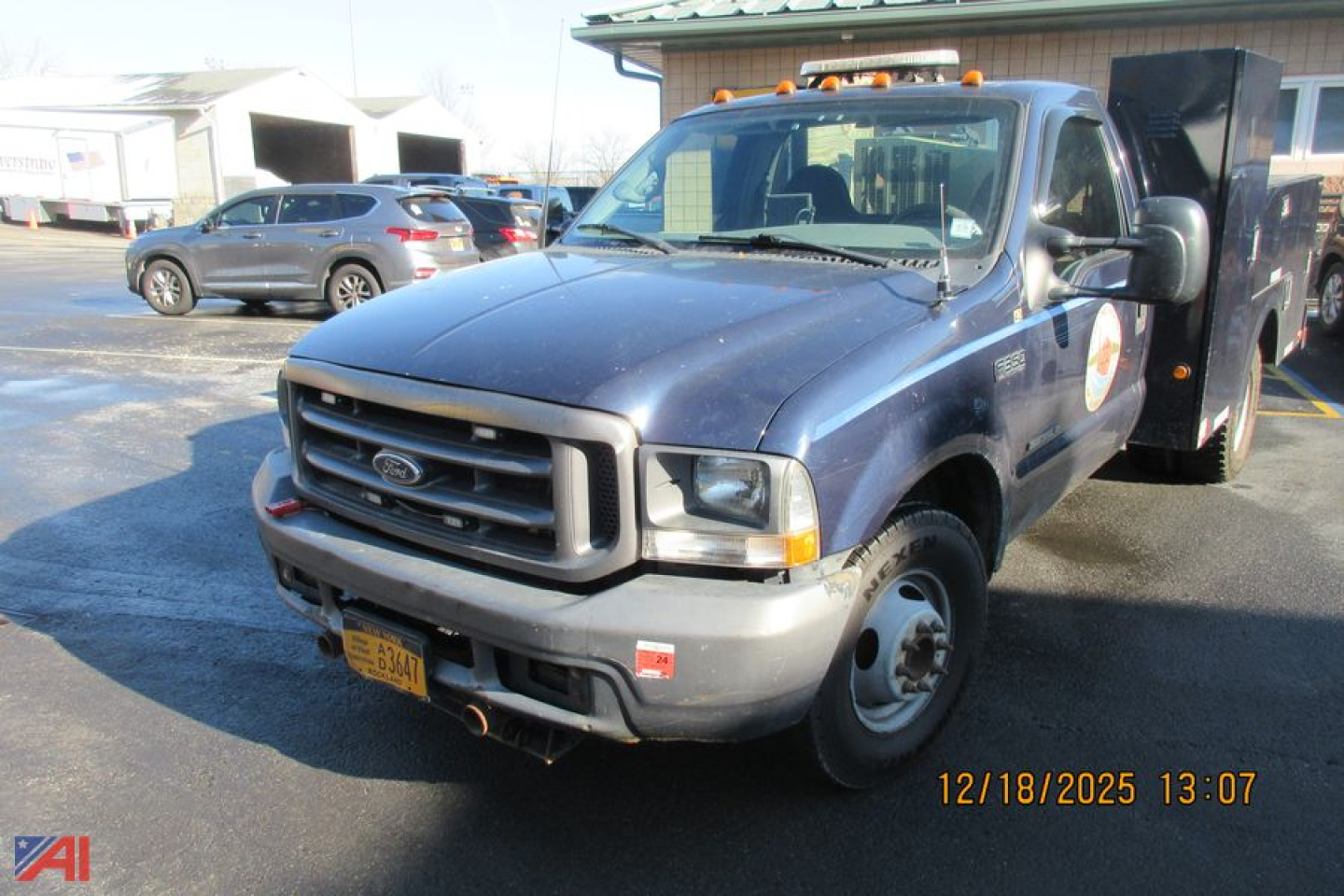 Ford F-350 Super Duty utility truck in blue, front view with utility bed, showing front grille, bumper, and passenger side; date stamp 12/18/2025.