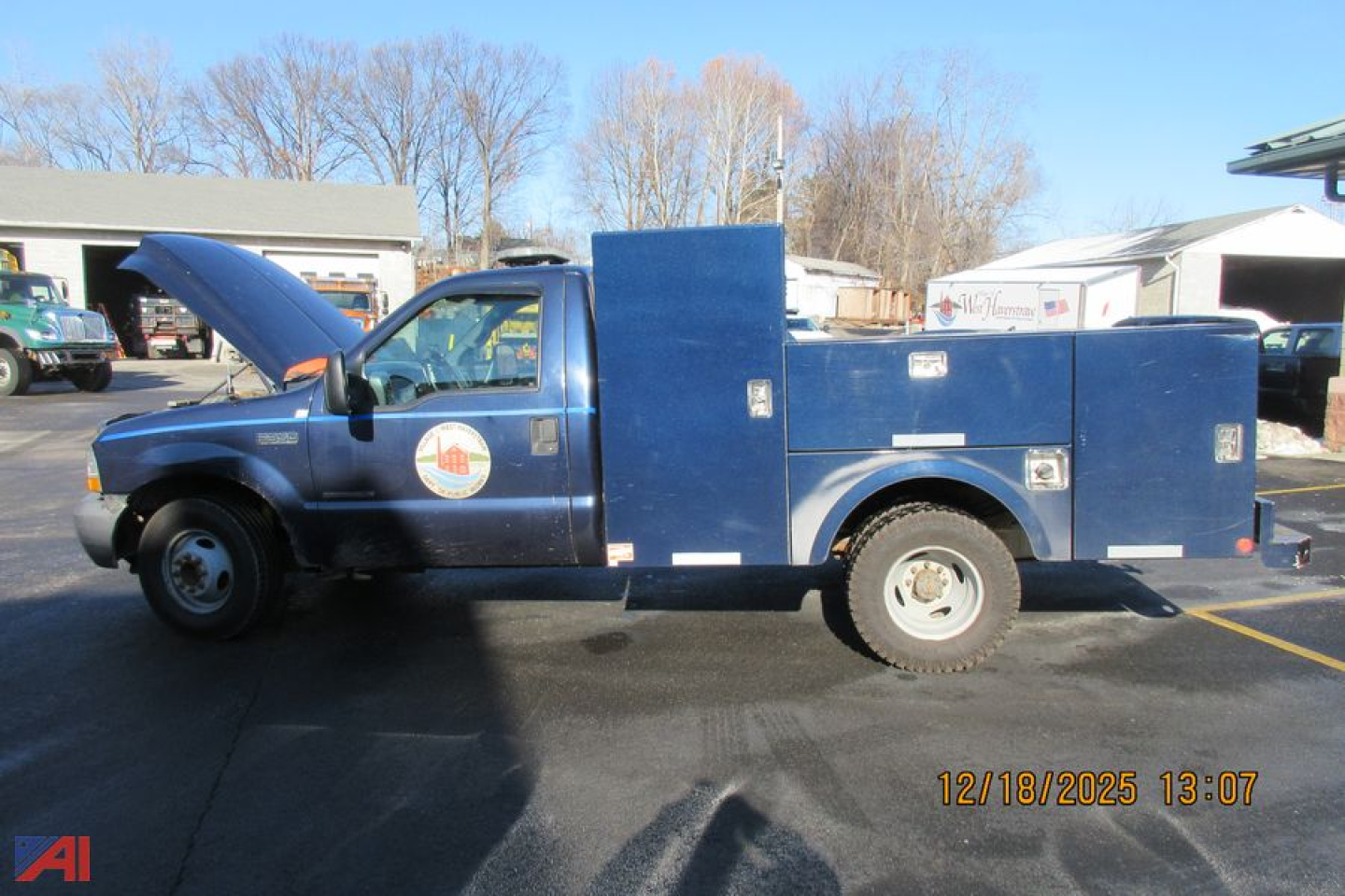 Ford F-350 Super Duty utility truck side view with a large service body and open hood.