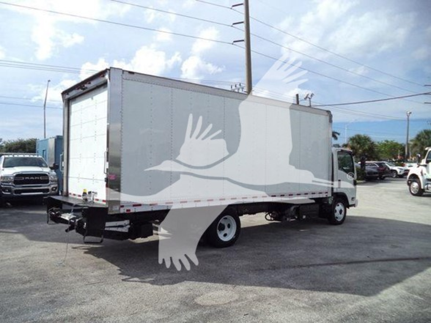 Isuzu NPR/NRR box truck rear and side view showing cargo box and cab, with white box body and black chassis.