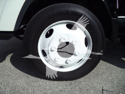 Isuzu NRR wheel close-up showing steel wheel with tire and hub cover